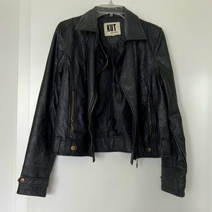 Black faux leather moto jacket with gold/bronze hardware
